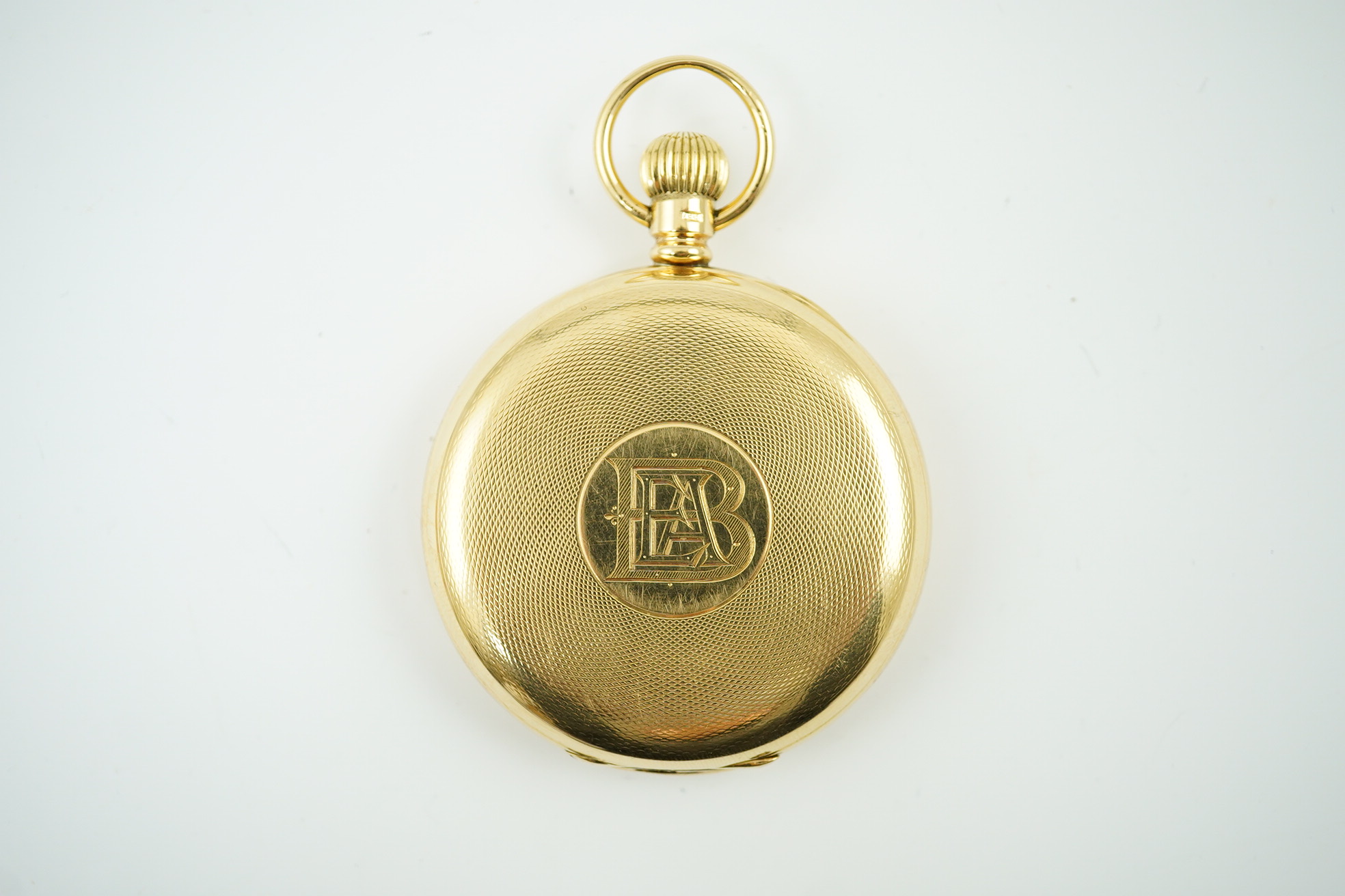 An Edwardian engine turned 18ct gold Waltham hunter keyless pocket watch